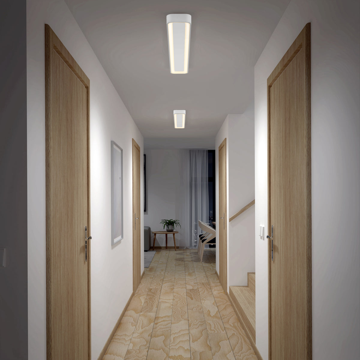 A well-lit hallway with light wooden floors and four closed wooden doors, two per side. Artika's Aiden 48 in. LED modern flush mount ceiling light brightens the space. At the end, a room features a plant, chair, and large curtain.