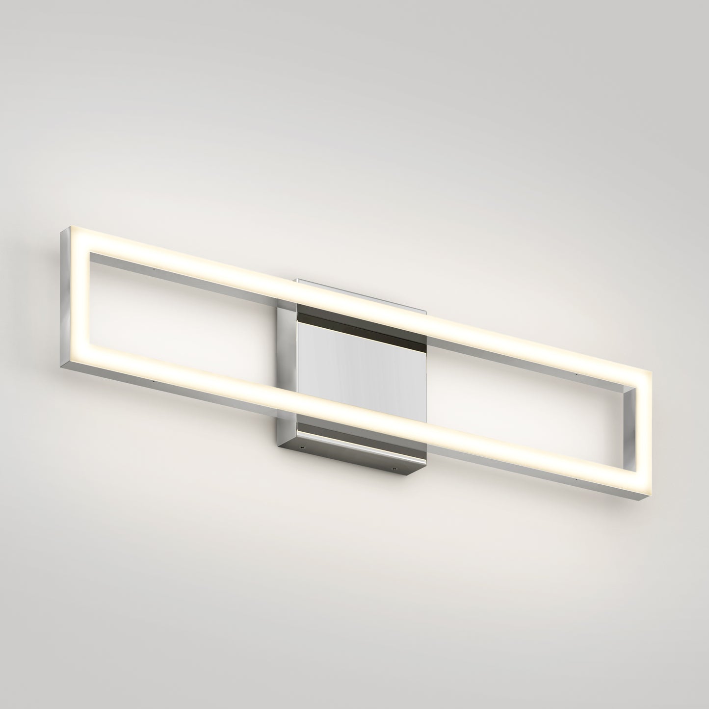 The Artika Dover modern LED bathroom vanity light 5 CCT features a chrome finish and a glowing rectangular frame on a central metallic base, shown mounted on a white wall.
