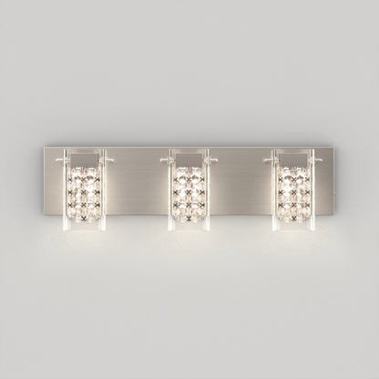 The Artika Crystal Cube LED bathroom vanity light 5 CCT features three rectangular lights with glass panels and sparkling crystal accents, mounted on a brushed metal backplate and displayed against a plain light gray background.