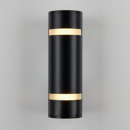 The Artika D4 indoor-outdoor wall light is a modern black cylindrical sconce with illuminated bands at the top and bottom, shown mounted on a light gray wall.