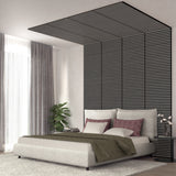 Modern bedroom with a neutral bed, mauve and white pillows, a green throw, and a tall black slatted accent wall extending onto the ceiling. Sheer curtains, a plant, and a robot decor piece are visible.