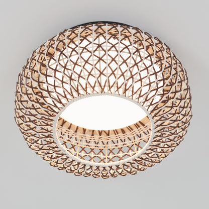 The Artika Benson 15 in. LED flush mount light features a circular, open-weave rattan design that mounts to a white ceiling, casting warm, decorative light through its woven pattern with customizable color temperatures.