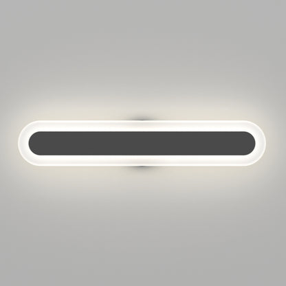 The Artika Pista modern LED bathroom vanity light 5 CCT features an oval design with a black center and glowing white border, mounted on a light gray wall.