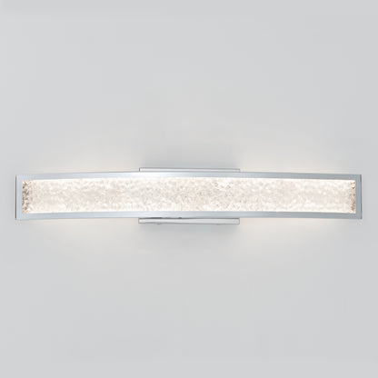 The Artika Glitter LED bathroom vanity light is a modern wall-mounted fixture with a curved rectangular design, featuring textured frosted glass and a chrome frame, shown against a plain white background.