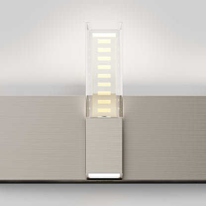 The Artika Hologram LED modern bathroom vanity light 5 CCT features a wall-mounted design with a rectangular metallic base and a transparent vertical panel showcasing multiple horizontal LED strips.