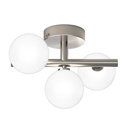 The Artika Bloom LED flush mount is a modern ceiling light featuring three frosted glass globes on a brushed nickel base with a horizontal rod.
