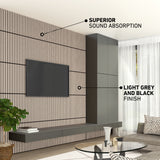Modern living room with a TV mounted on a wall featuring vertical light grey and black slatted panels, a floating shelf beneath, tall cabinets, and notes highlighting superior sound absorption and the light grey and black finish.