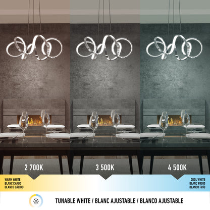 A modern dining room features Artika's Swirl Ribbon LED pendant light, displayed in three tones—warm white (2700K), neutral white (3500K), and cool white (4500K)—each casting distinct illumination on the table and wall.