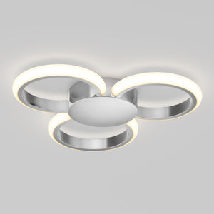 The Artika Nyala 15 in. LED flush mount light features three circular LED rings emitting soft white light, arranged in a triangular pattern on a central metallic base.