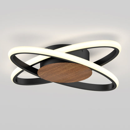 The Artika Atomic 15 in. LED flush mount light features intersecting black rings with glowing LED bands, mounted on a circular wooden base, offering modern style and adjustable 5 CCT lighting.