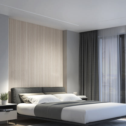 Modern bedroom featuring the Artika Panolok 30.67 ft wall panel kit (pack of 8) as a slatted accent wall behind a gray bed, with white and gray bedding, dark curtains, a nightstand with a plant, and large windows for natural light.
