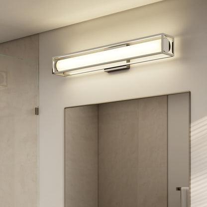 A modern bathroom showcases the Artika Venicia LED Wall Sconce above a large mirror, complemented by beige tiled walls and a glass shower door to the side.