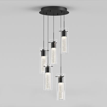 The Artika Essence 5-light LED pendant features five cylindrical glass lights hanging at varying lengths from a round black ceiling mount, offering a soft glow for a contemporary, elegant look.