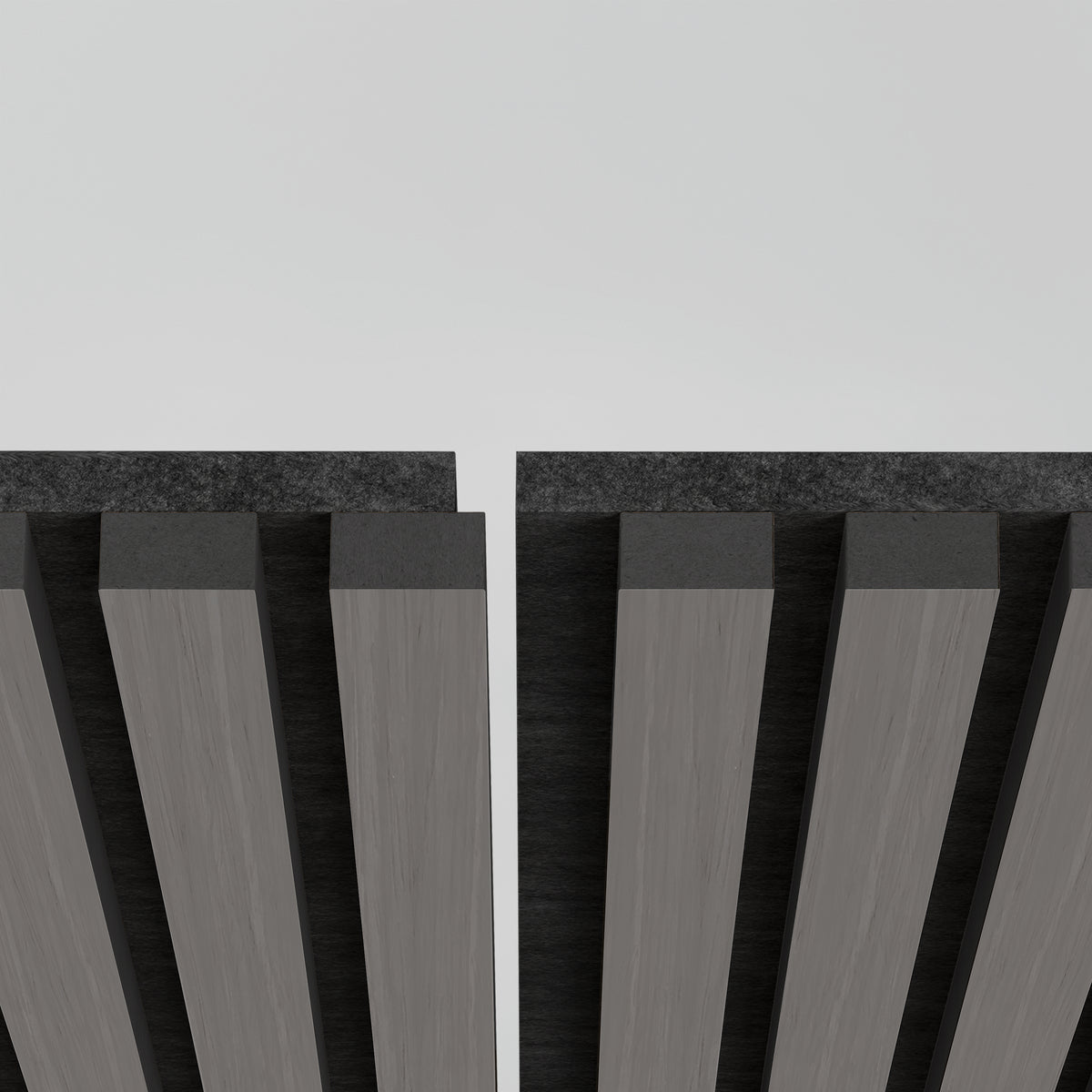 Close-up view of two parallel, vertical slatted panels with dark tops and gray surfaces, separated by a narrow gap, against a plain white background.