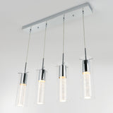 Modern rectangular ceiling light fixture with four hanging pendant lights, each featuring a cylindrical glass shade and chrome accents, suspended by thin cables, illuminated against a plain white background.