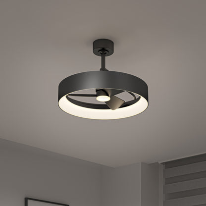 The Artika Austin 23 in. LED modern ceiling fan, featuring a circular black frame and built-in light fixture, is mounted on a white ceiling in a minimalist room with gray walls and horizontal window blinds. Includes remote control.