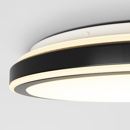 Close-up view of the Artika Altitude 15 in. LED modern flush mount light with 5 CCT, featuring black and white rings and built-in LED lighting, mounted on a white ceiling.