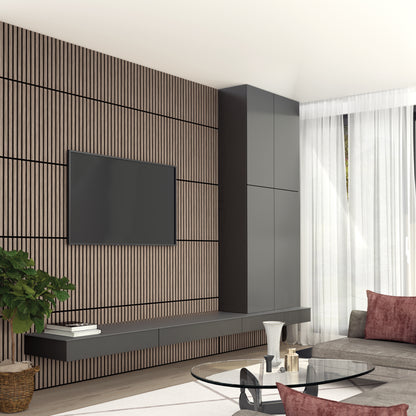 Modern living room featuring an Artika Sonolok 15.5 ft sound-absorbing wall panel kit, wall-mounted TV, dark floating shelf and cabinets, gray sofa, glass coffee table, potted plant, and large windows with white curtains.