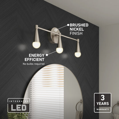 The Artika Wayden LED mid-century bathroom vanity light 3 CCT, featuring a brushed nickel finish and three energy-efficient integrated LEDs, is mounted above a round mirror on a dark herringbone wall. Includes a 3-year warranty.