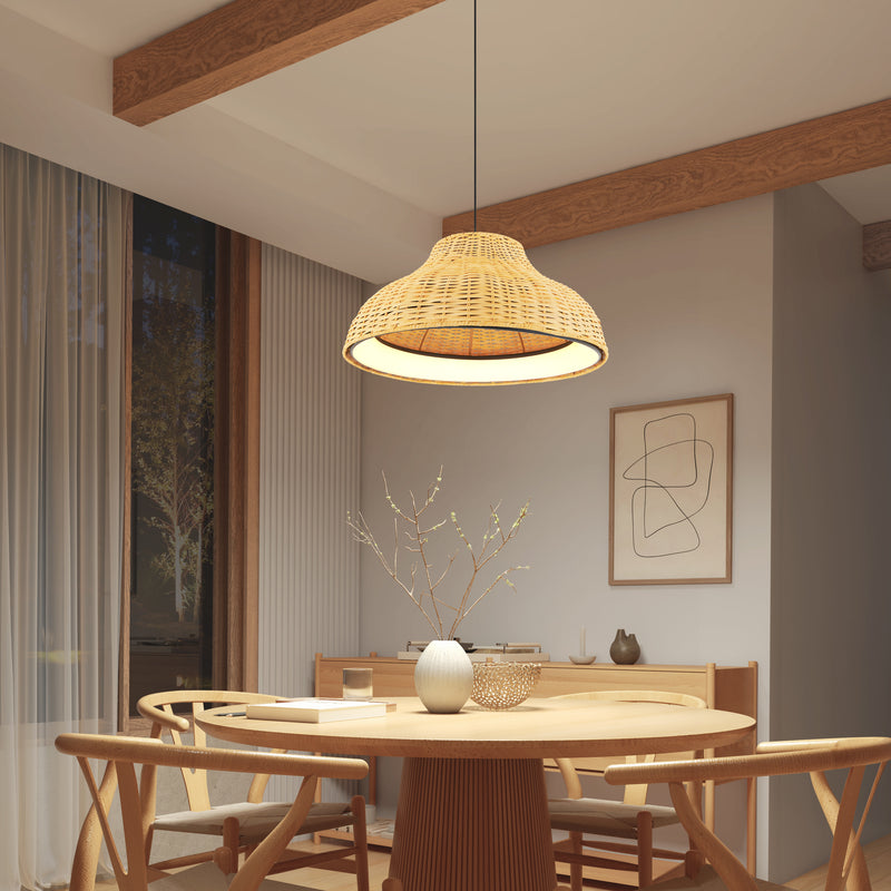 A cozy dining area features a round wooden table, four matching chairs, a white vase with branches, modern wall art, and the Artika Raina LED pendant light 5 CCT overhead. Warm lighting and large curtained windows create an inviting atmosphere.