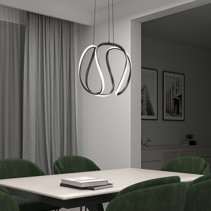 A modern dining room features Artika’s Vivaldi Big LED pendant light (5 CCT) as a sculptural centerpiece above a white table with green velvet chairs; gray curtains and monochrome architectural art complete the look.