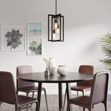 A modern dining area with a round dark wood table, four brown chairs, three decorative vases, framed wall art, a contemporary pendant light, and a green potted plant in the corner.