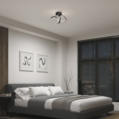 A modern bedroom with a low gray bed, white and gray bedding, two abstract art pieces, dark blinds, and Artika’s Loop modern LED flush mount light 3 CCT—a unique black ceiling fixture with curved loops.