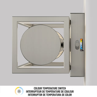 The Artika Venicia LED Wall Sconce, featuring a square metallic frame with a circular center, is wall-mounted beside a color temperature switch offering four icon-labeled options with a small triangle indicator.