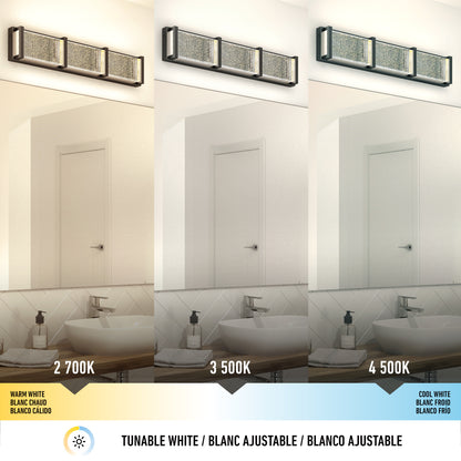 The Artika Subway Essence 3 LED bathroom vanity light is shown above a mirror in a modern bathroom, illuminating the scene at three color temperatures: 2700K (warm white), 3500K (neutral white), and 4500K (cool white).