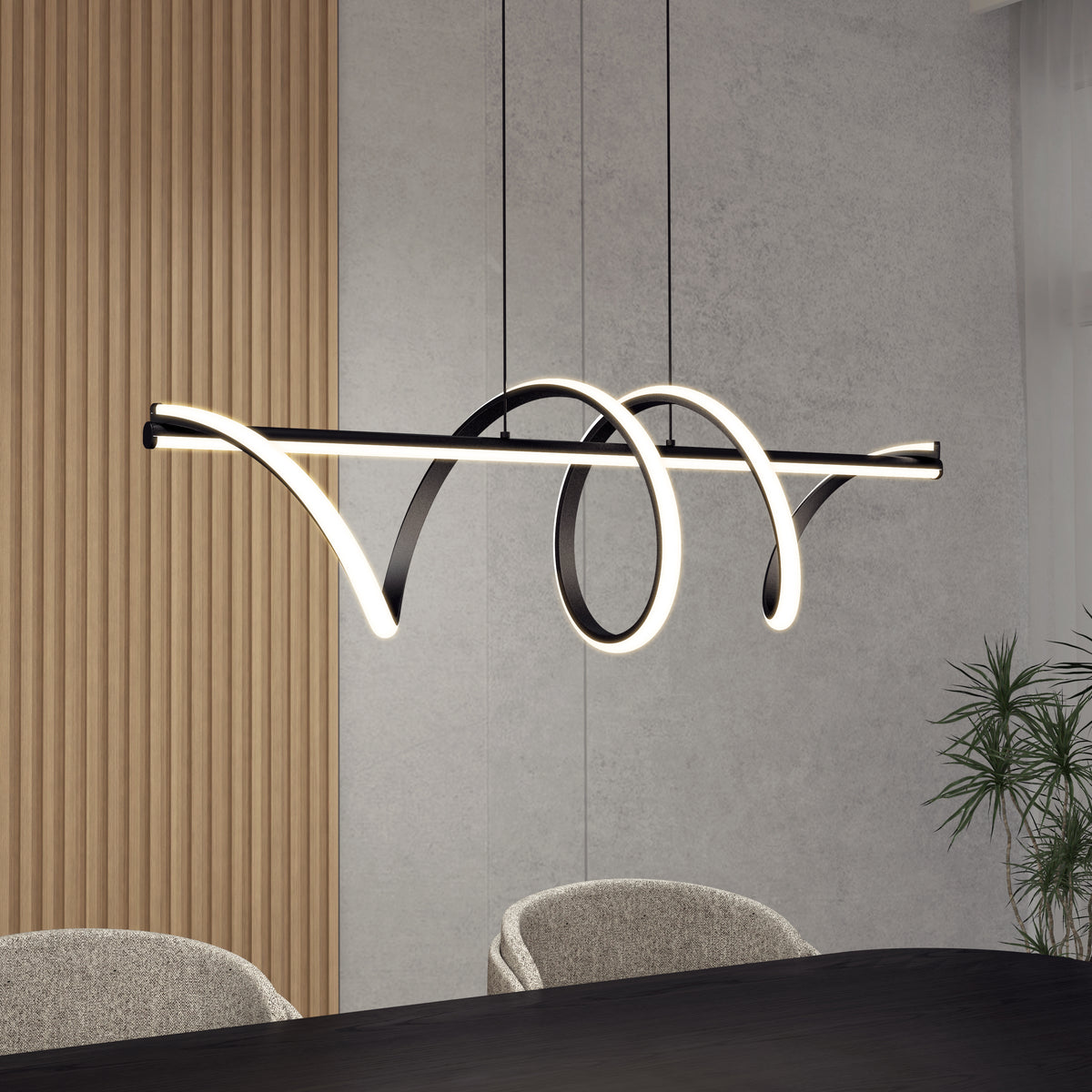 A modern pendant light with a black frame and glowing LED strip forms abstract loops, hanging above a dark dining table with beige chairs; wood panel and grey walls in the background.