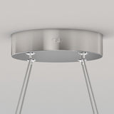 A close-up of a metallic ceiling canopy with four cables attached, likely for suspending a modern light fixture, against a plain white ceiling.