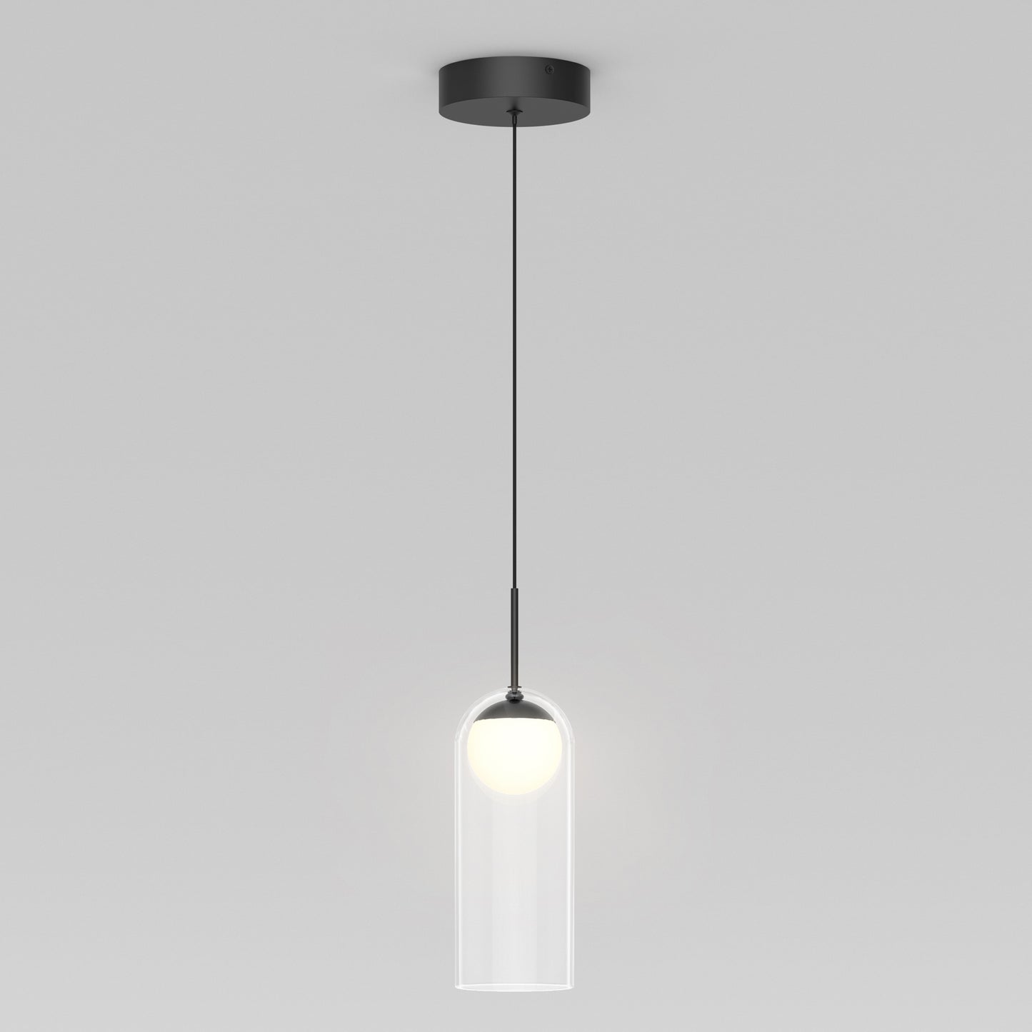 The Artika Mirah LED modern mid-century pendant light 3 CCT features a black ceiling mount and cord, with a clear cylindrical glass shade showcasing the glowing bulb, shown hanging against a plain white background.