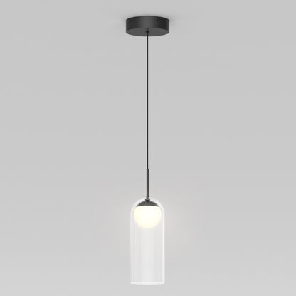 The Artika Mirah LED modern mid-century pendant light 3 CCT features a black ceiling mount and cord with a clear cylindrical glass shade around a glowing white bulb, shown against a plain gray background.