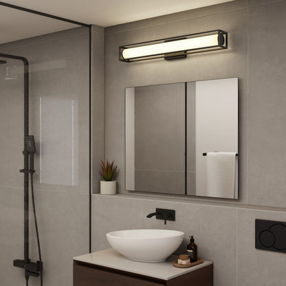 Modern bathroom with the Venicia LED Wall Sconce by Artika above a rectangular mirror, vessel sink on wooden vanity, black faucet, soap dispenser, small plant, and glass shower door.