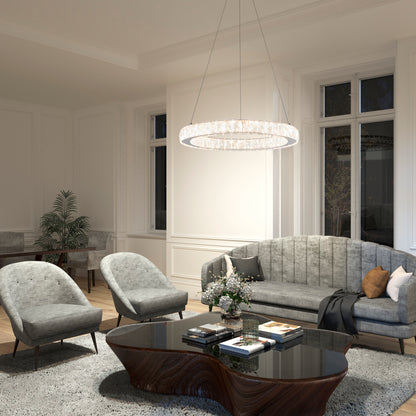 Modern living room with gray upholstered sofa and armchairs, black oval coffee table, books and flowers, large tall windows, a plant and desk in the background; ceiling features the Artika Celebrity LED pendant light.