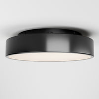 The Artika Aiden LED flush mount is a modern, round black ceiling light with a smooth finish and white diffuser, shown installed on a plain white ceiling.
