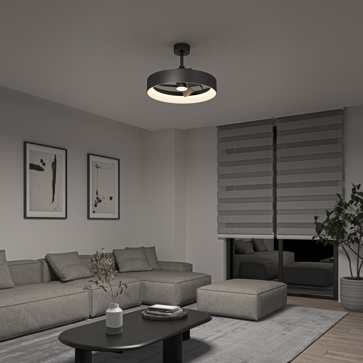 A modern living room with a gray sectional sofa, a black coffee table, abstract wall art, a large plant, and a round ceiling light. The window has striped gray blinds and the room is decorated in neutral tones.