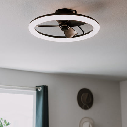 The Artika Darren 23 in. LED modern ceiling fan features a circular design, mounts on white ceilings in rooms with gray walls and teal curtains, and includes a remote for effortless control.