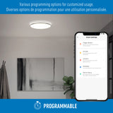 A ceiling light in a modern room is shown next to a smartphone displaying smart settings for lighting. Text above offers programming options in English and French. An icon and PROGRAMMABLE label appear at the bottom.