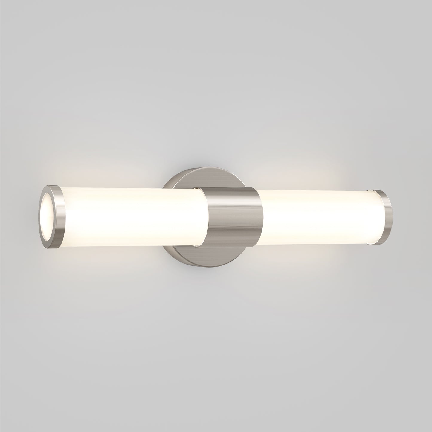 The Artika Adina modern bathroom vanity light 3 CCT features a sleek wall-mounted design with two horizontal frosted glass shades and a brushed metal base, casting soft white light against a plain light gray wall.