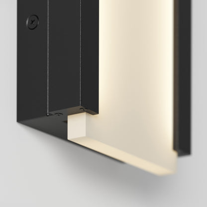 A close-up of the Artika Blade indoor-outdoor LED wall light emits a soft, warm glow against a white wall, highlighting its sleek, minimalist design and geometric lines.