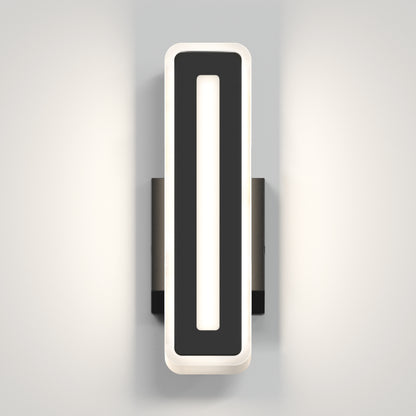The Artika Evasion modern indoor-outdoor LED wall light 3 CCT features a rectangular black frame and vertical white illuminated center, mounted on a light gray wall to cast soft, dual-sided light.