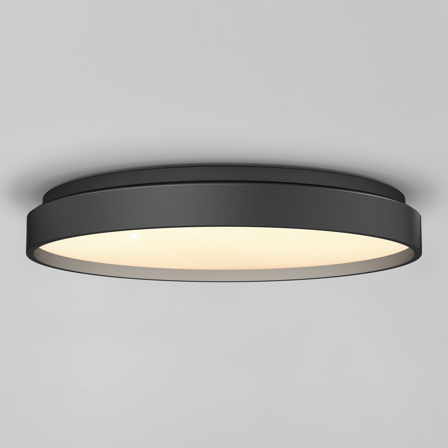 The Artika Celestia 15 in. modern LED flush mount light with remote is installed on a smooth gray ceiling, offering a stylish black finish and soft glowing illumination.