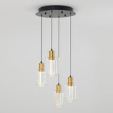 A modern ceiling light fixture with four hanging pendant lights, each featuring a gold-toned base, clear glass shade, and black cords attached to a round black ceiling mount.
