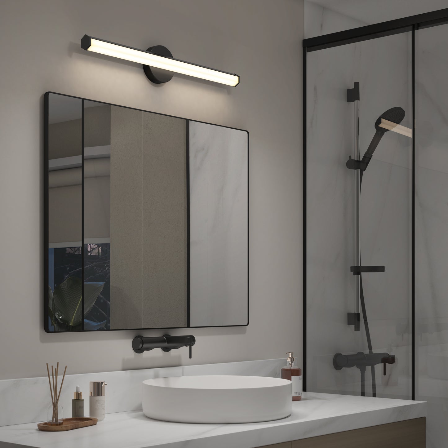 Modern bathroom with a round white sink, black fixtures, large rectangular mirror, and the Artika Ewen modern LED bathroom vanity light 5 CCT above it. Glass shower with black hardware on the right; minimalist countertop decor.