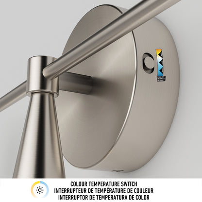 Close-up of the Artika Wayden LED mid-century bathroom vanity light 3 CCT, showing a brushed metal finish and a base label with “Colour Temperature Switch” in English, French, and Spanish next to a sun icon.