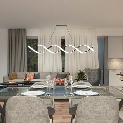 Modern dining and living area with a glass table set for four, gray upholstered chairs, an Artika-CAN-dev DNA Linear LED modern pendant light in matte black, and a cozy sofa by large windows with sheer white curtains.