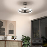 A modern ceiling fan with a circular LED light fixture is mounted on a white ceiling in a stylish living room. The room features abstract wall art, a rattan cabinet, a green plant, and large windows.