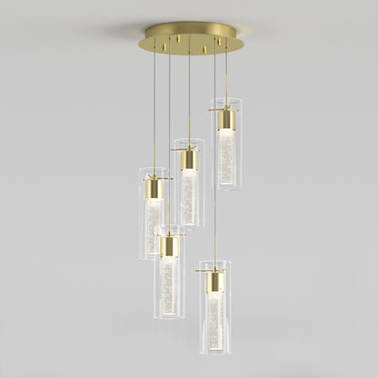 The Artika Essence 5-light LED pendant features five cylindrical glass shades suspended at varying heights, showcased against a plain light gray background.