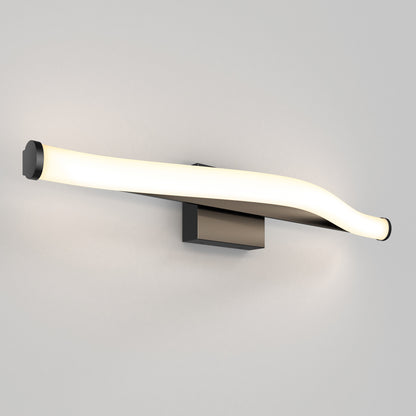 The Artika Arc modern LED bathroom vanity light 5 CCT features a slim, curved glowing white bar with black ends, mounted on a rectangular black base against a plain light-colored wall.